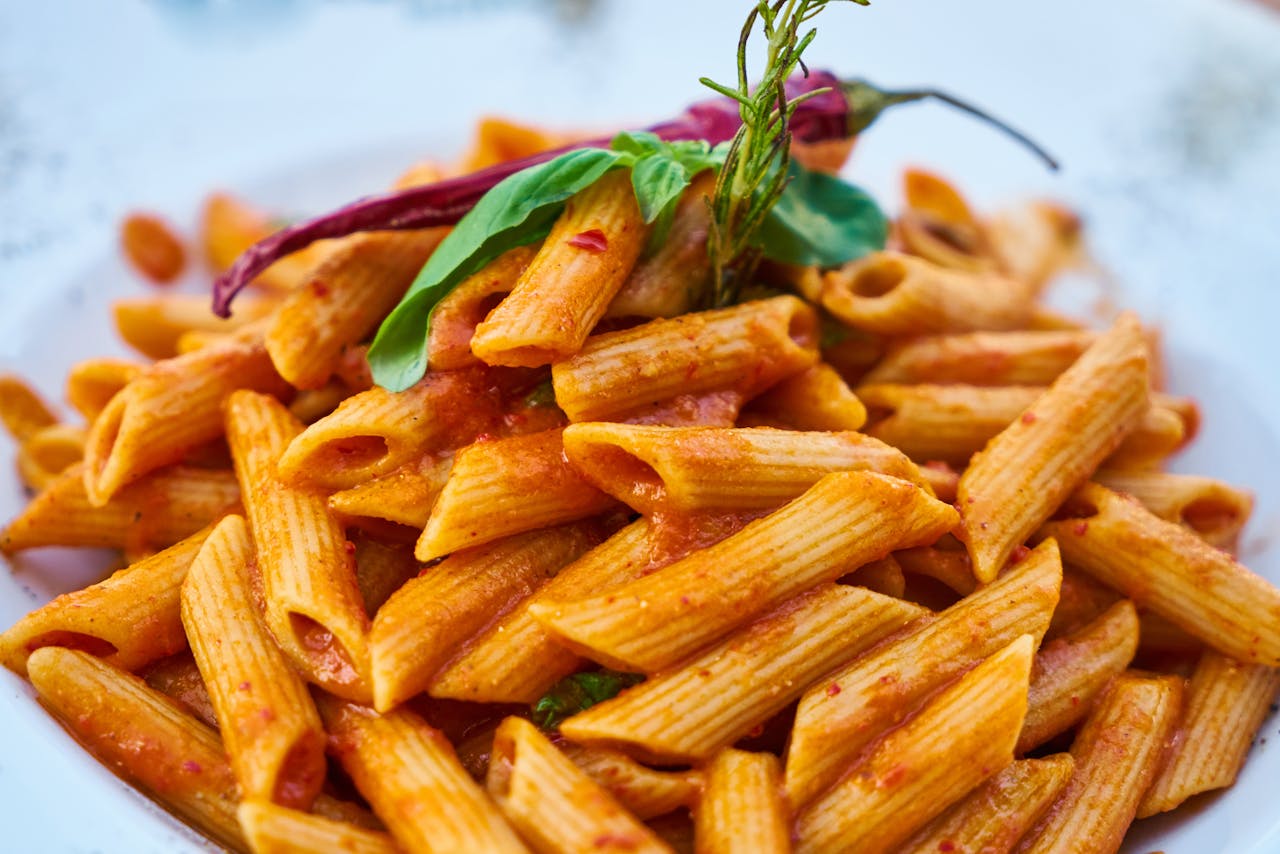 who-we-are Savor the flavors of Italian cuisine with this close-up photo of tasty penne pasta in tomato sauce.